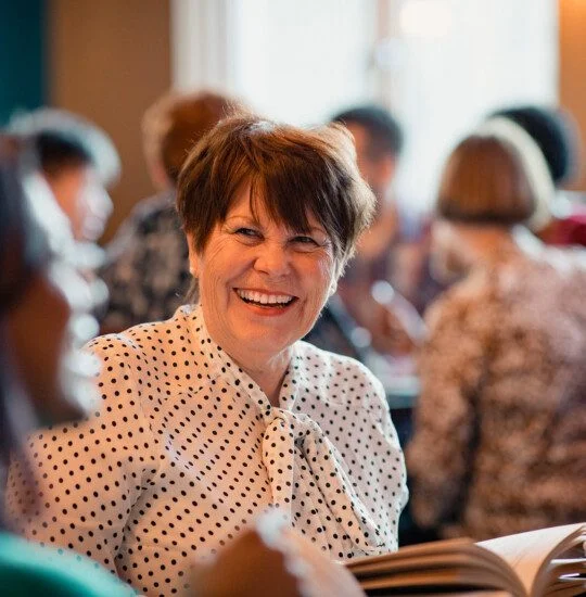 seniors laugh and converse during book club