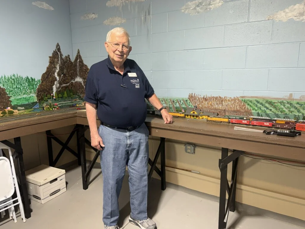 Paul Prell with the model train landscape at Oak Trace senior living community in Downers Grove