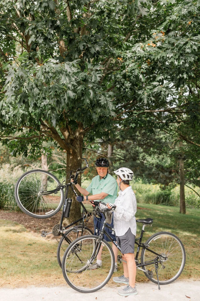 Chris Laperuto and Bill Roznowski with their bikes on the Oak Trace campus