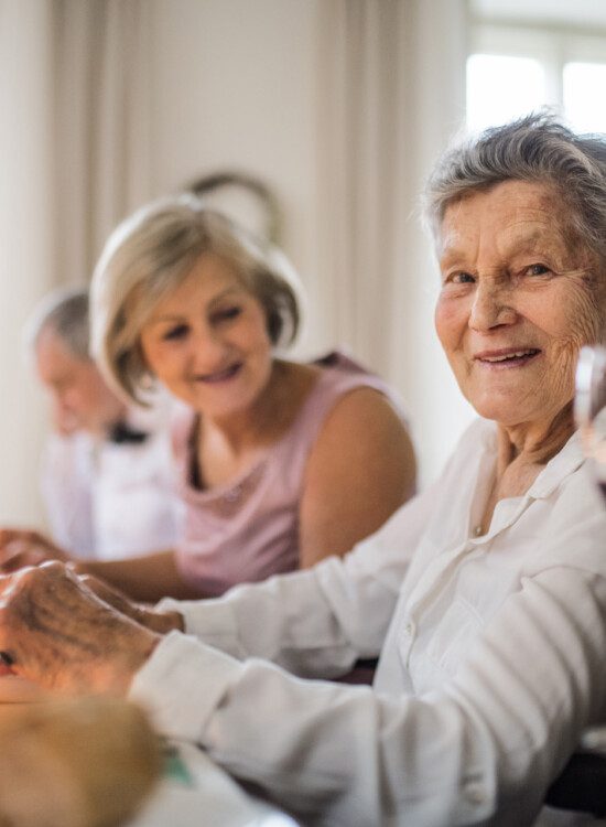 group of senior women enjoy an elegant dinner together