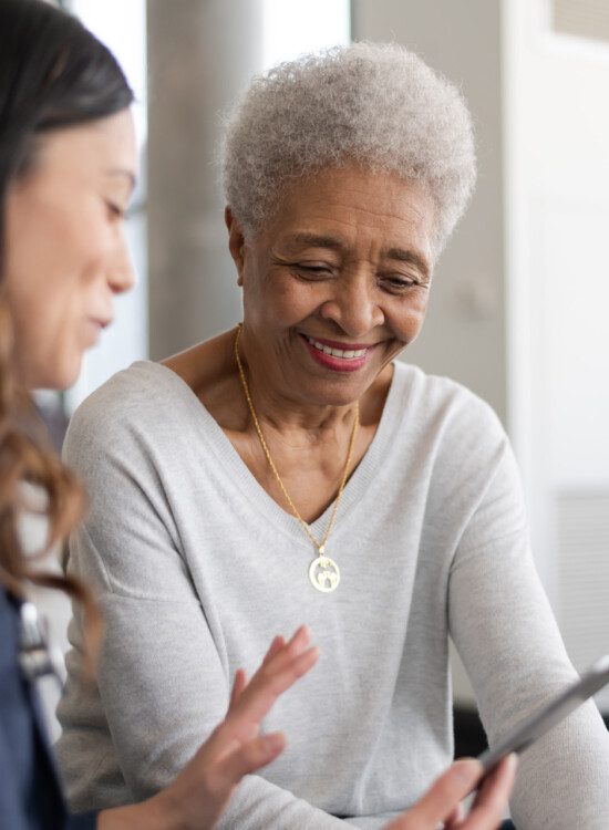 senior woman receives counsel from her caregiver about medication management