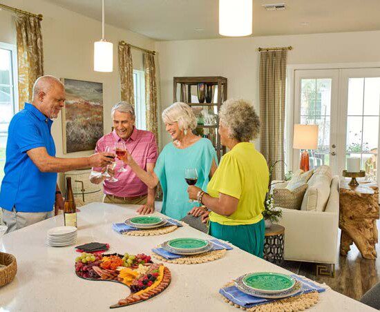 group of seniors gather in a villa home for snacks, drinks, and games