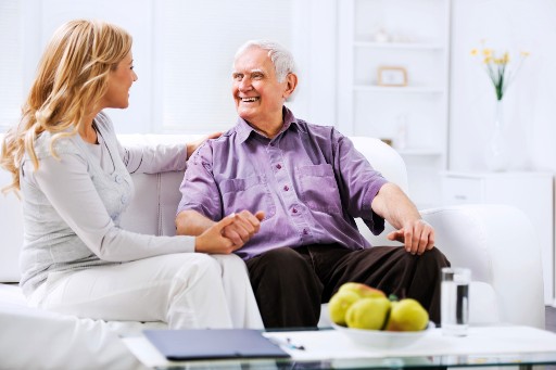 elderly man talking about memory care with his daughter