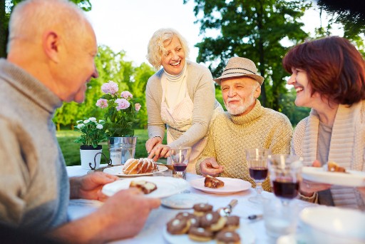 group of seniors eating outside their independent living community