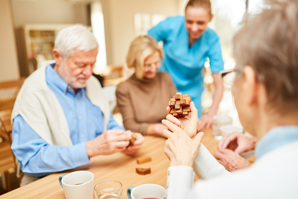 Seniors and caregivers playing games together
