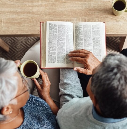 Senior man and woman read the Bible together