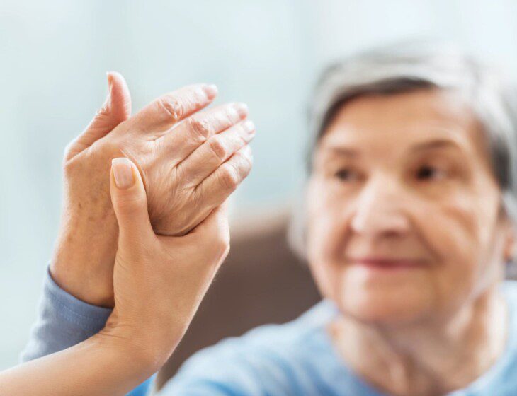 Senior woman receives hand therapy at Oak Trace Senior Living Community