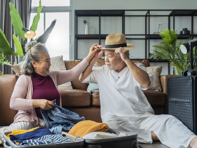 Senior couple packing their bags for vacation.