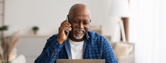 Mature Man Talking On Cellphone And Using Laptop Mature Man Talking On Cellphone Using Laptop